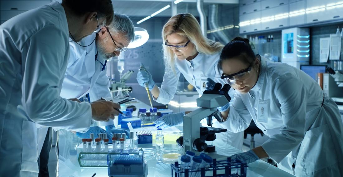 Scientists in a lab utilizing laboratory equipment.