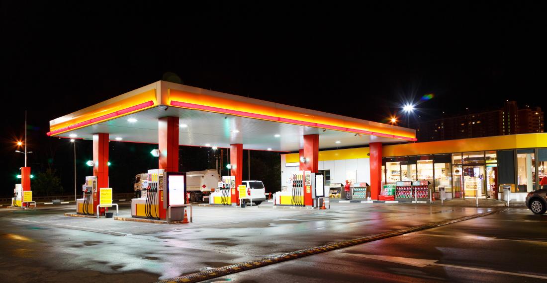 Lit up gas station at night.